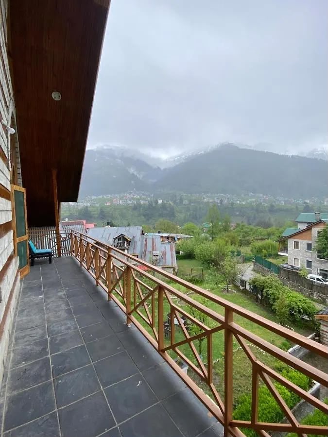 Hillside balcony of a luxury stay in Mussoorie looking out over misty forested hills