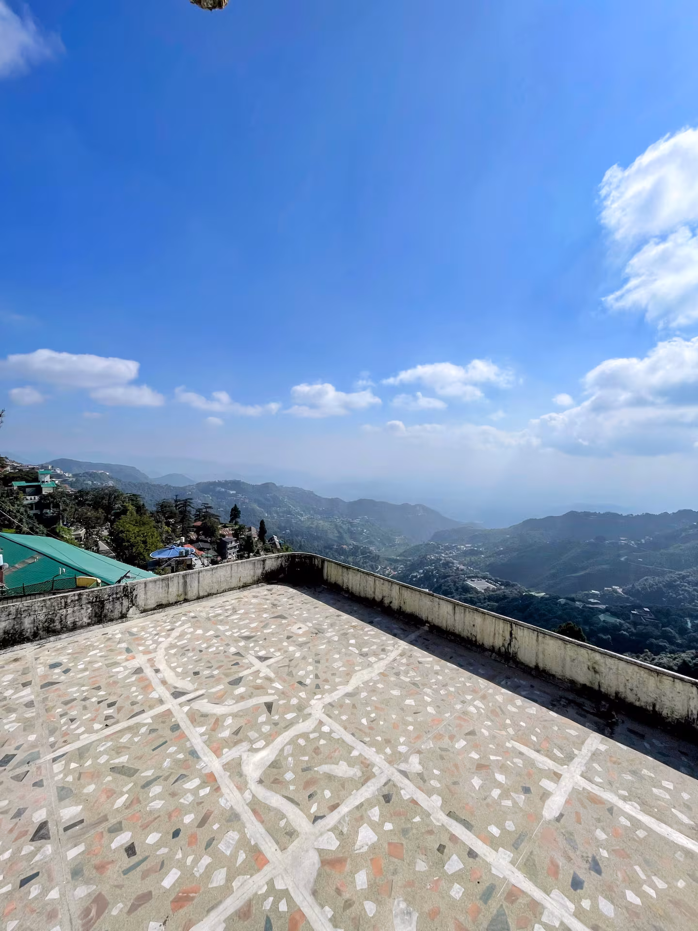 Huge private terrace with open valley views under a blue sky at Polaris Alpine, Mussoorie