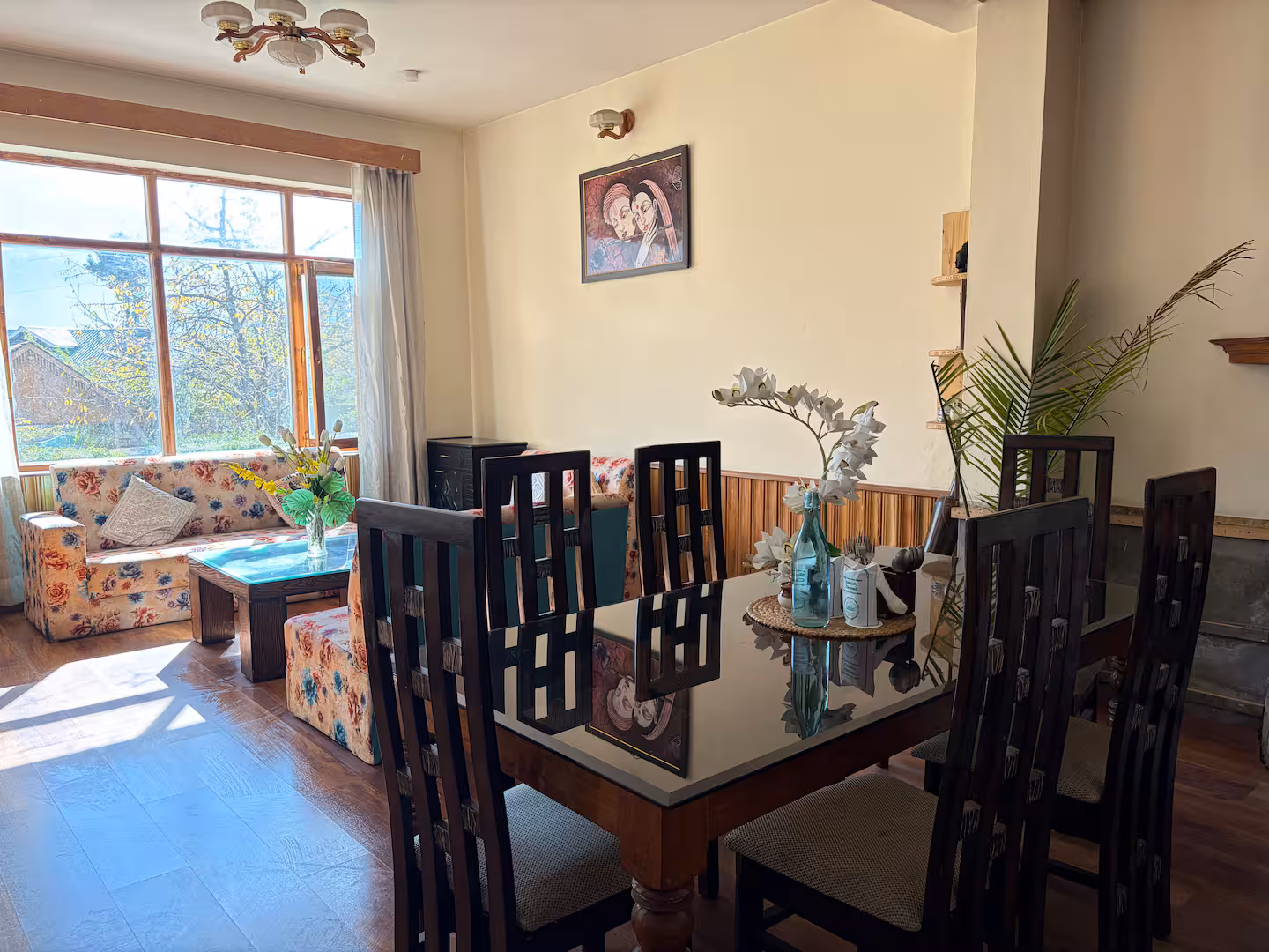 Dining table beside the living area at Polaris Himalayan Chalet, Simsa, Manali