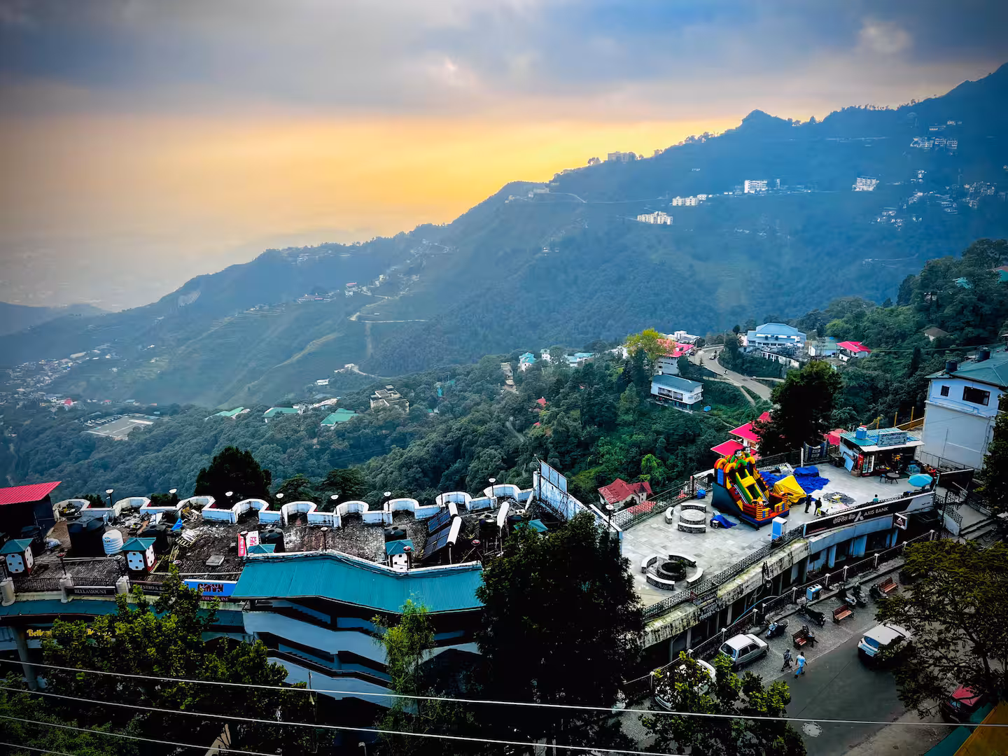 Golden morning light over the hillside town and forested valley at Polaris Alpine, Mussoorie