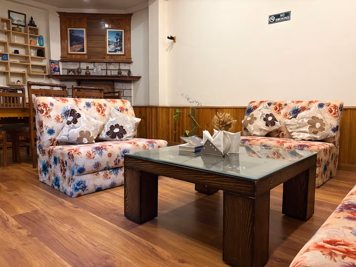 Second lounge with floral sofas and low table at Polaris Himalayan Chalet, Manali