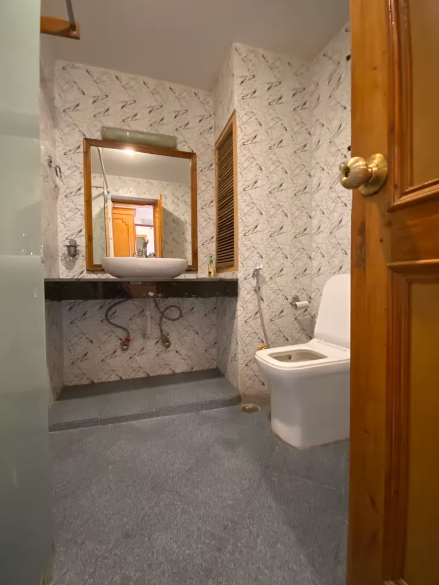Attached bathroom with vessel basin and mirror at Polaris Himalayan Chalet, Manali