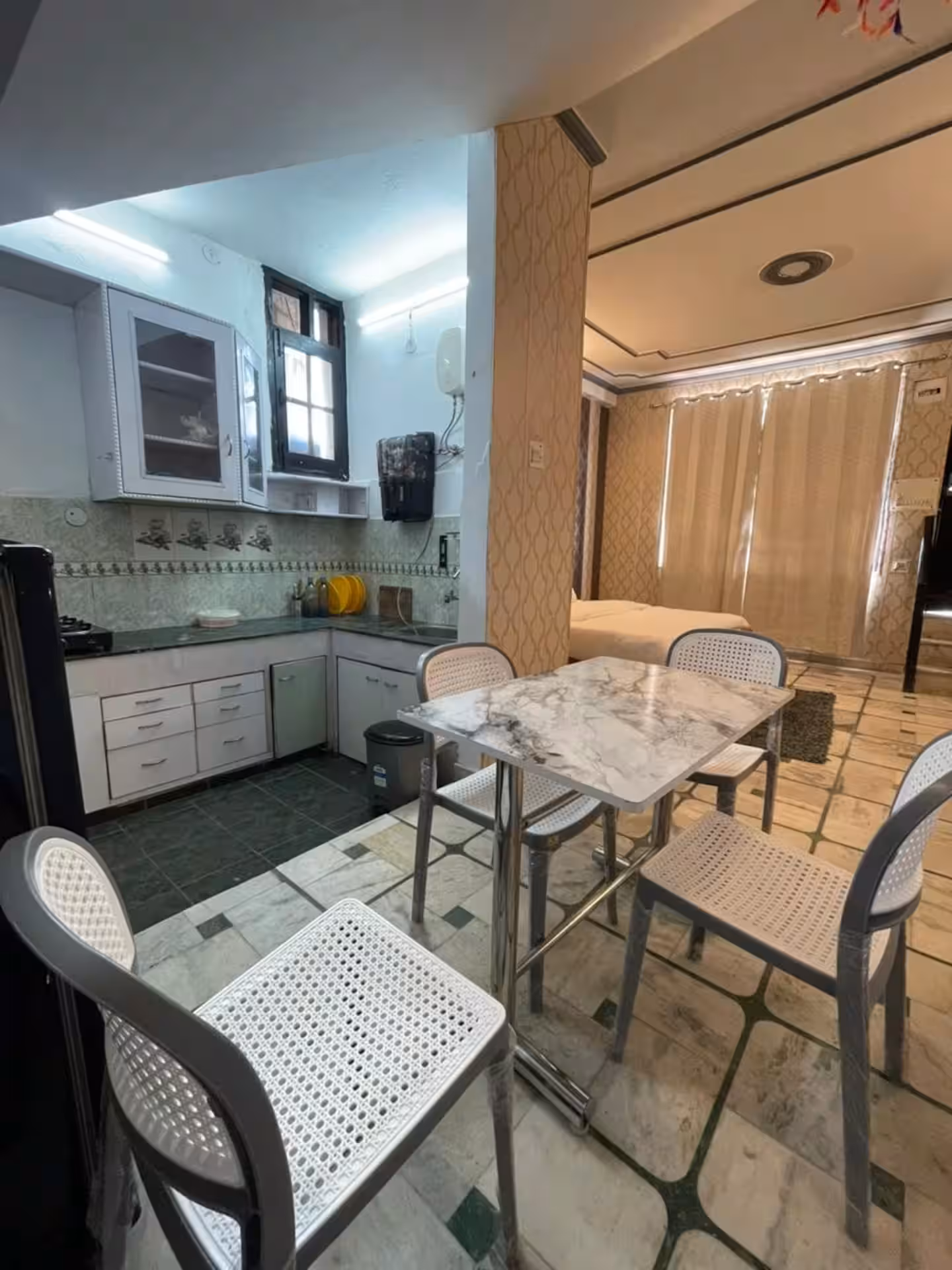 Fully equipped kitchen with small dining area at Polaris Alpine, Mussoorie
