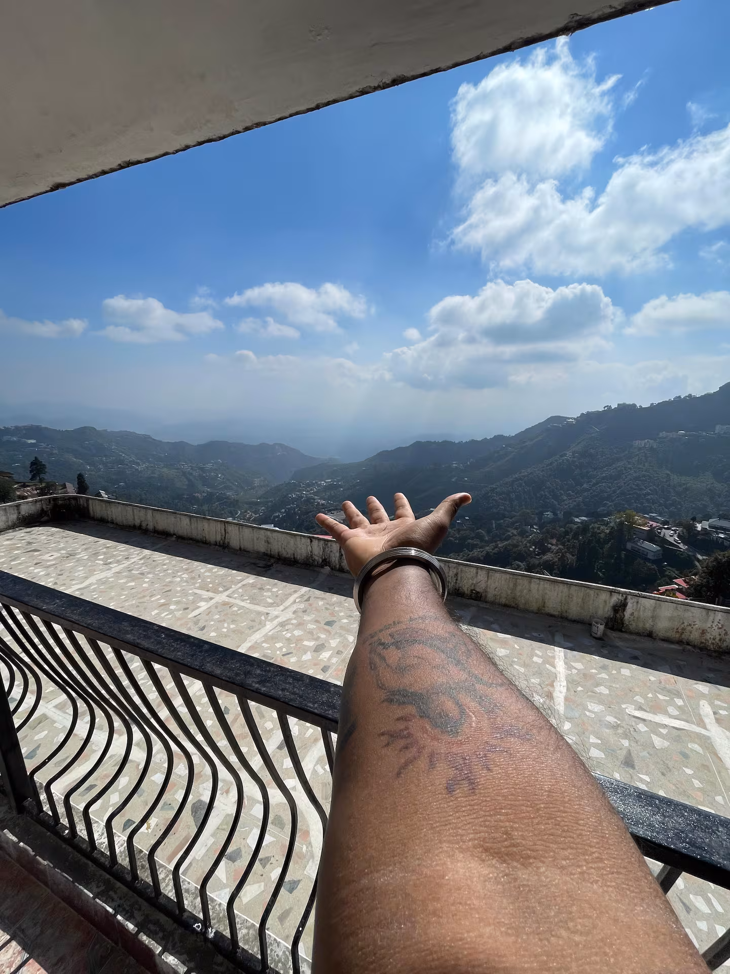 Private balcony railing looking out over the misty Himalayan hills at Polaris Alpine, Mussoorie