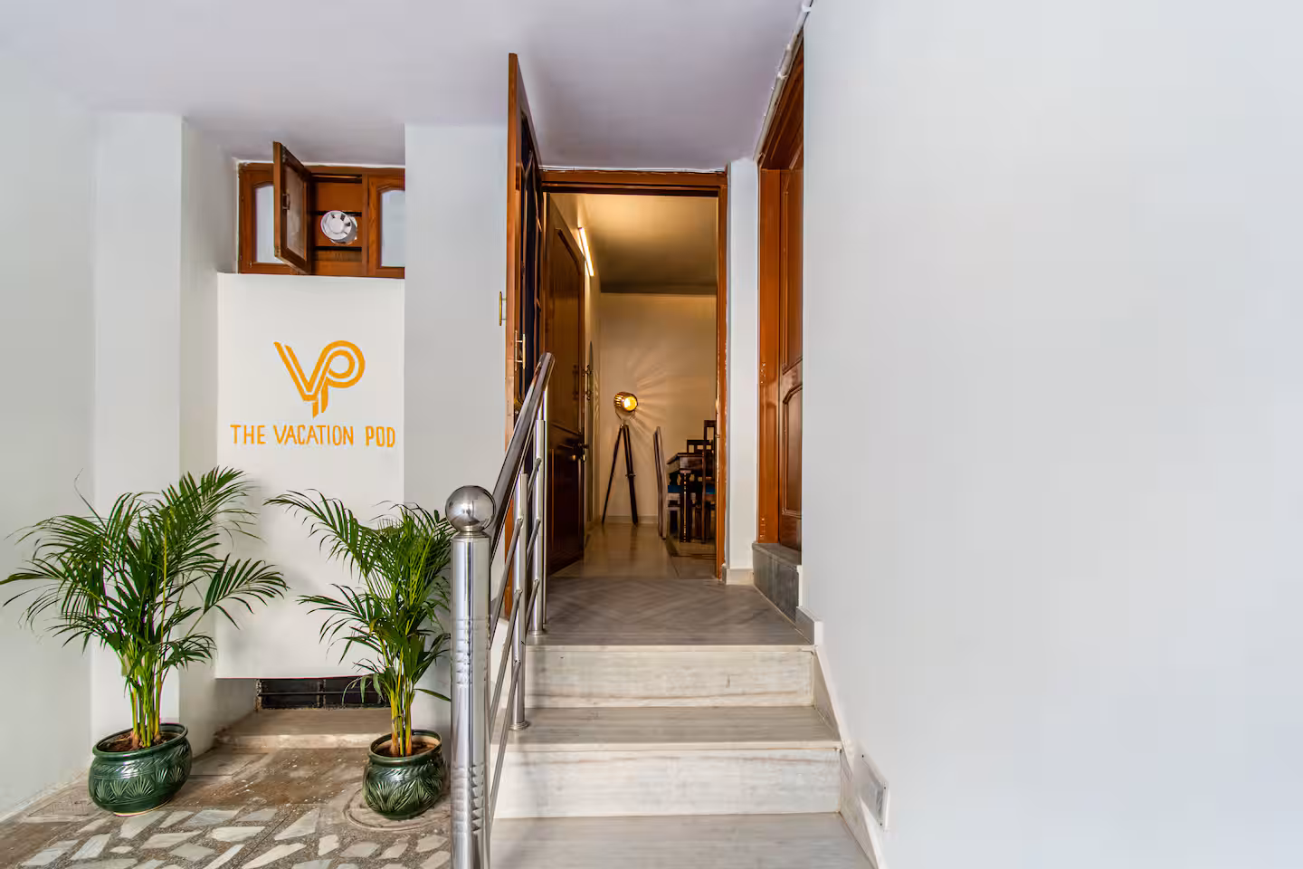 Entry stairway with signage and planters leading into the villa at Polaris Art Terrace, Jaipur
